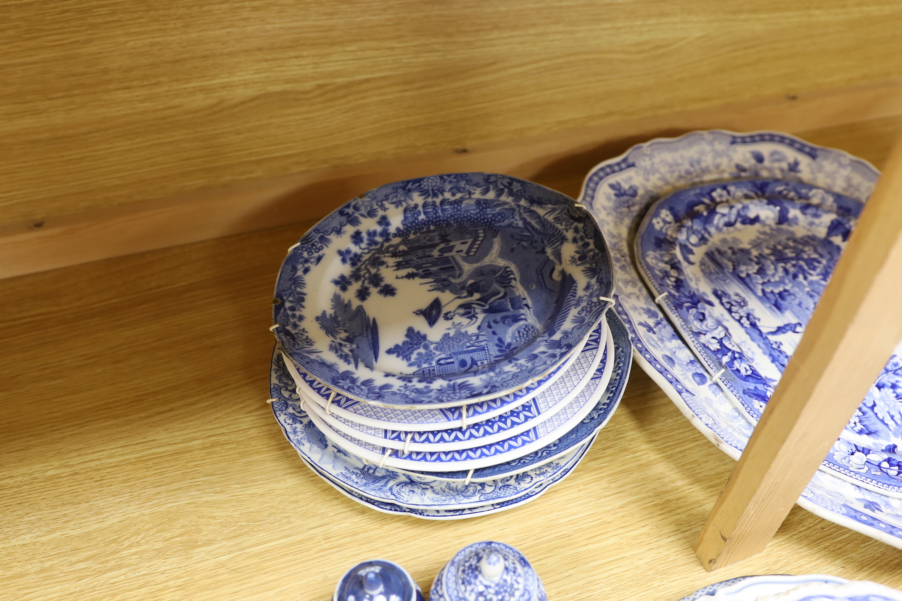 An early 19th century John Meir and Sons blue and white printed 'Fairy Villas' meat dish together with a collection of Staffordshire and other blue and white dishes and two baluster jars and covers, the largest 50cm wide